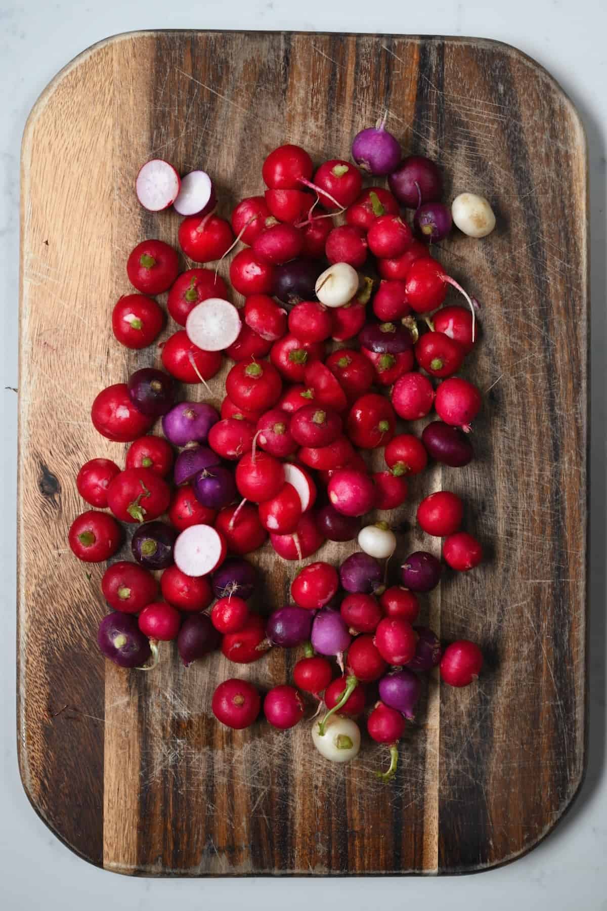 Washed and trimmed radish on a board