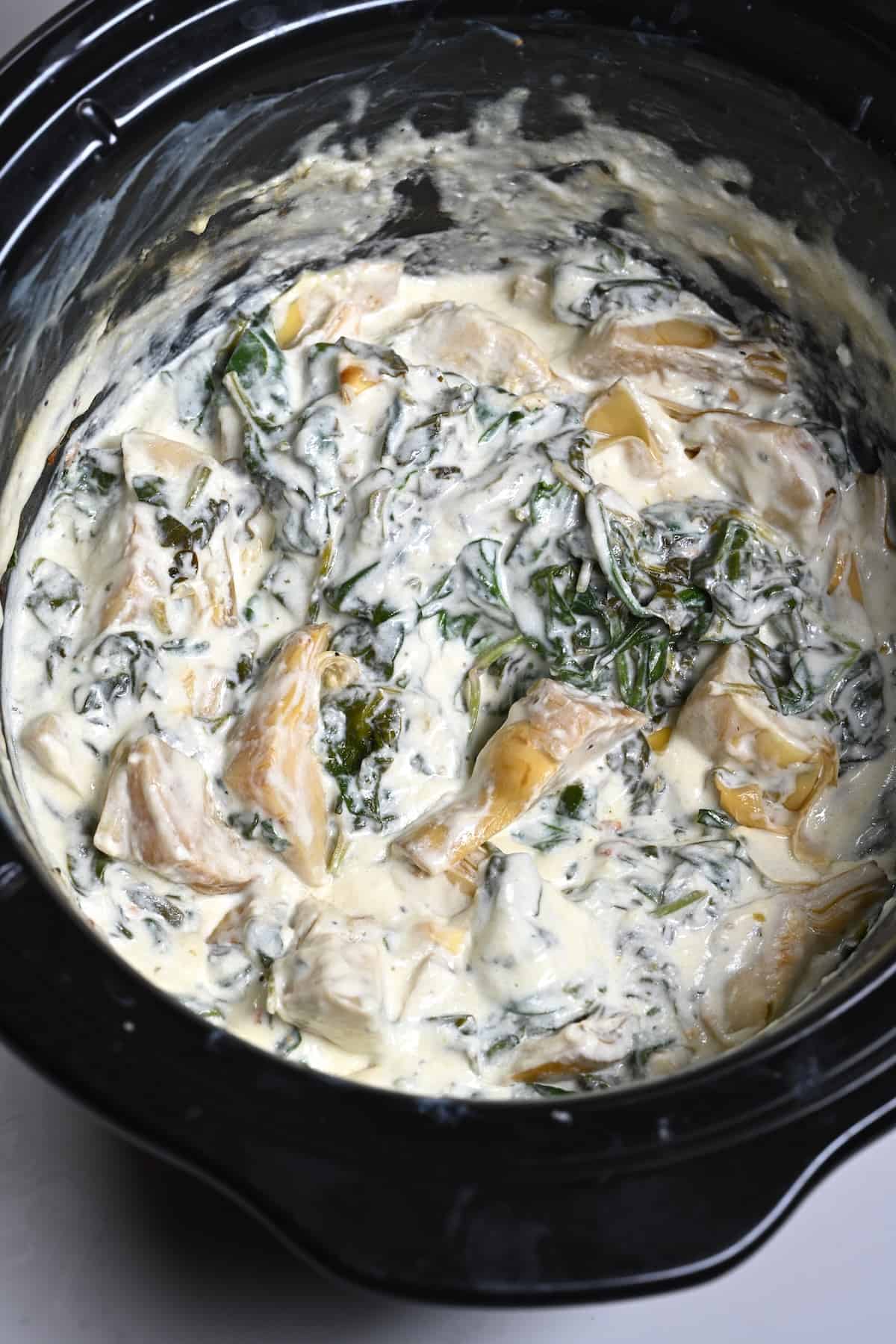 Artichoke and spinach dip made in a crockpot