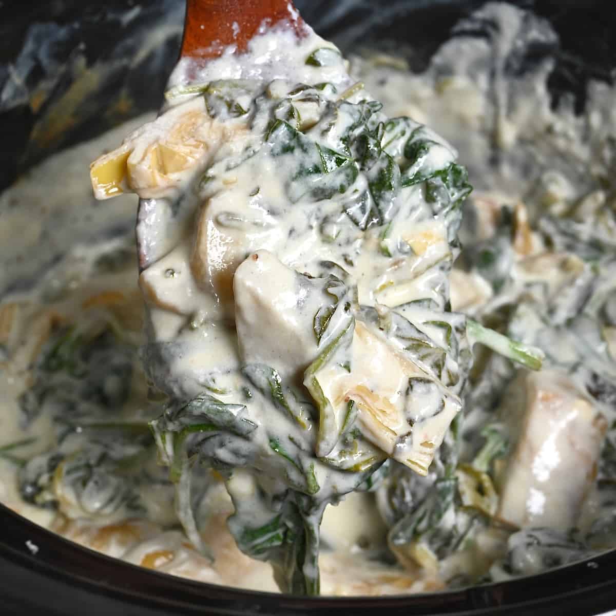 A spoonful of crockpot spinach artichoke dip