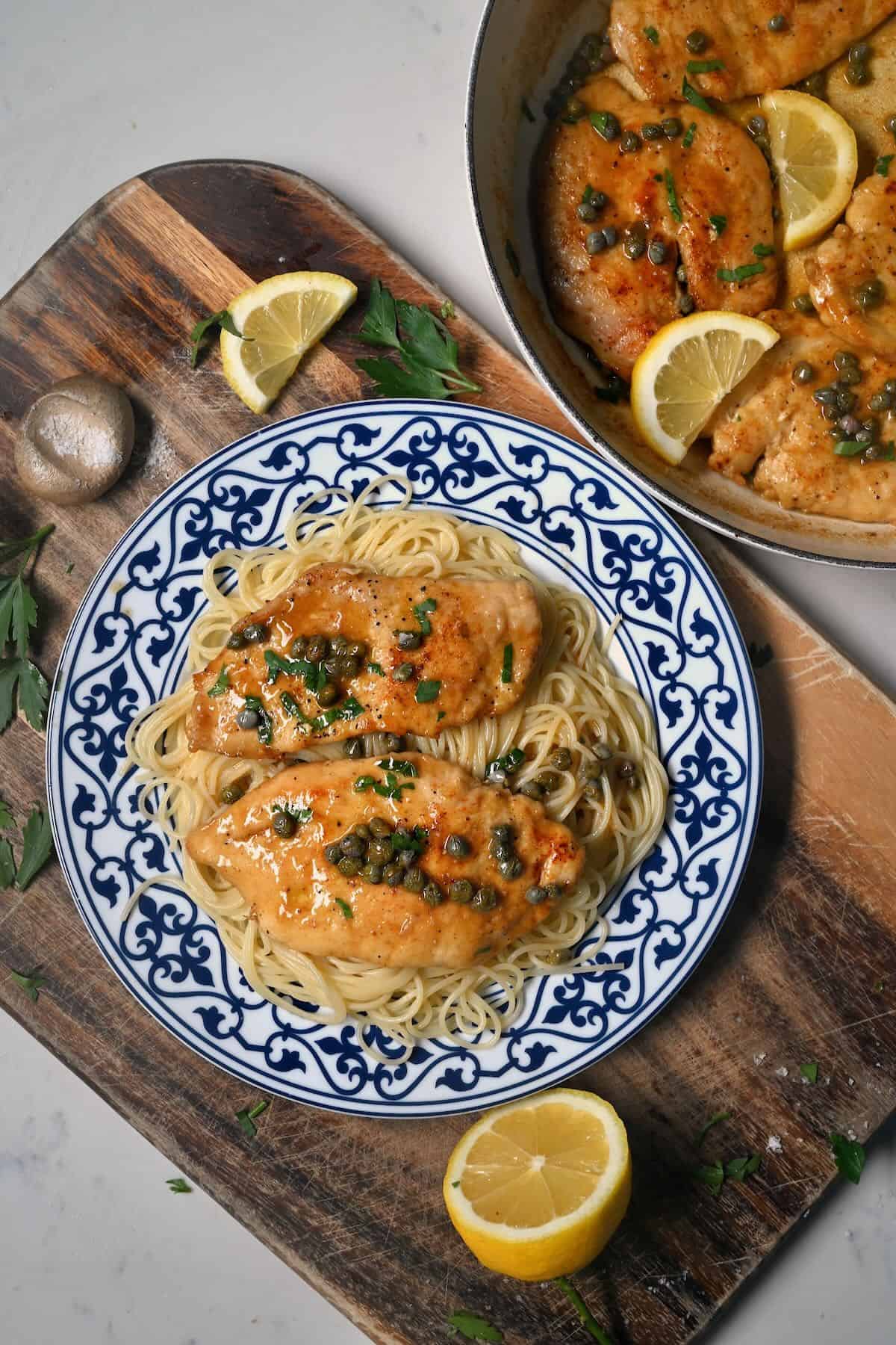 A serving of chicken piccata with spaghetti