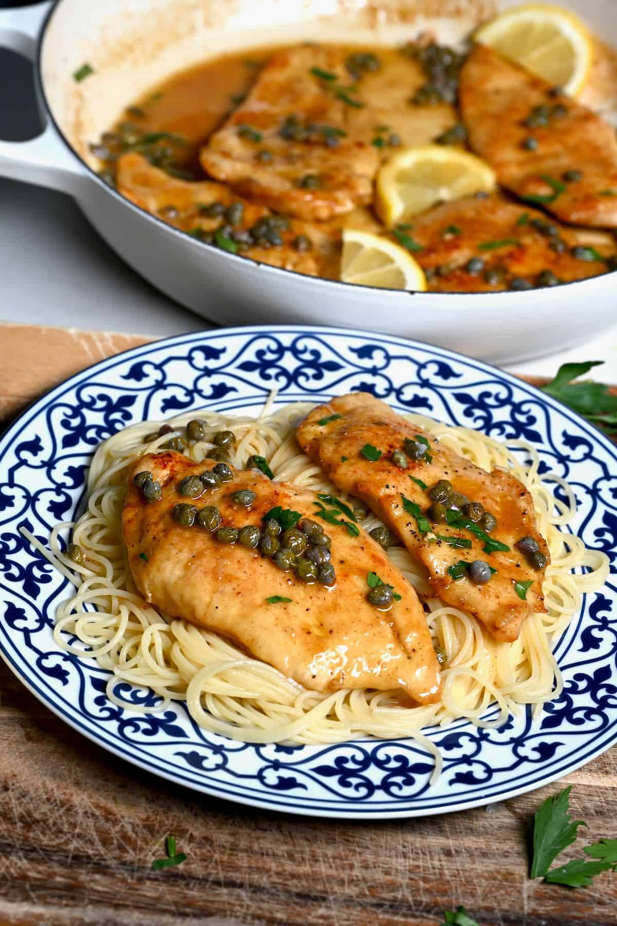 A serving of chicken piccata with spaghetti