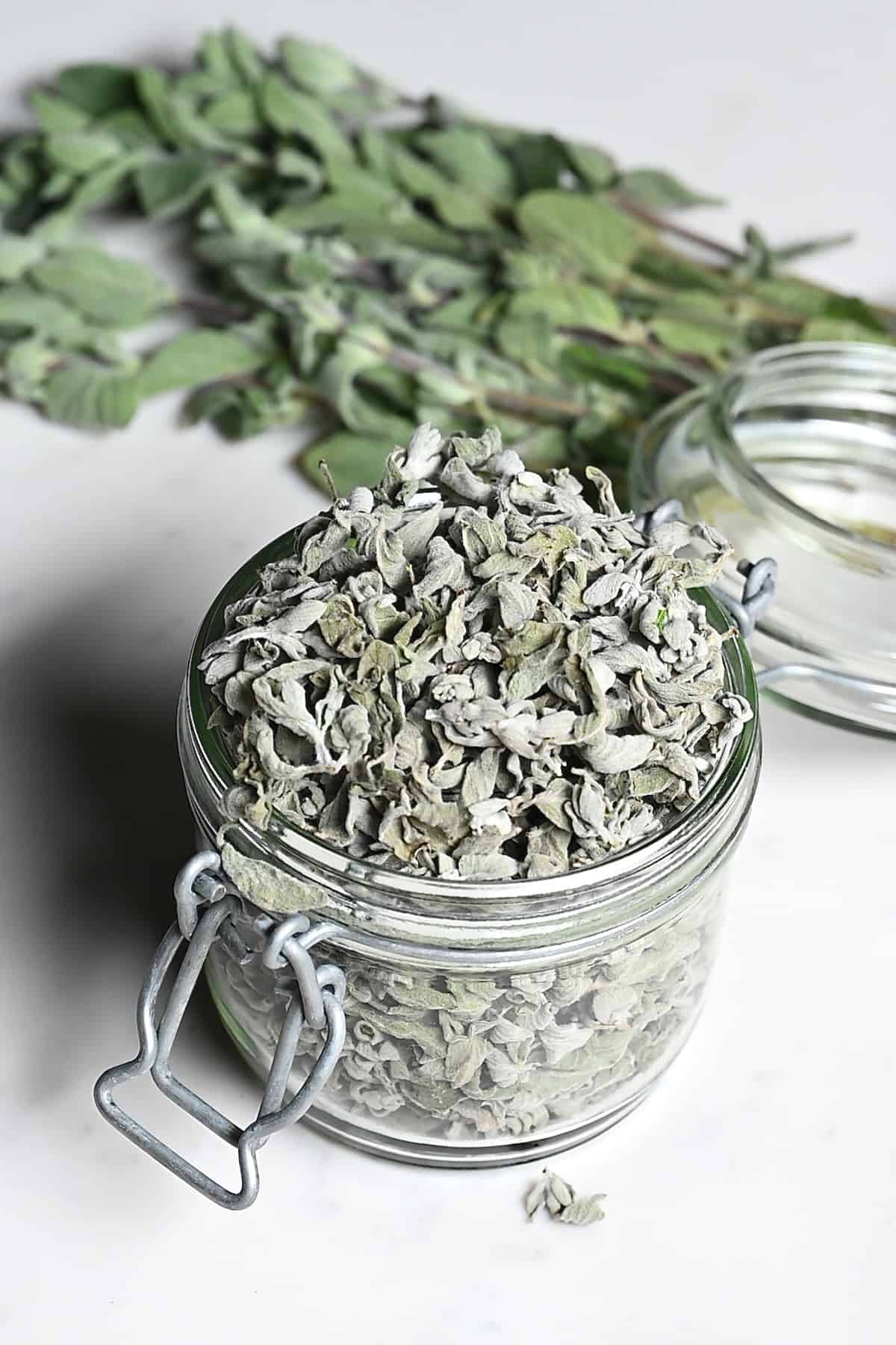 A jar with dried oregano leaves