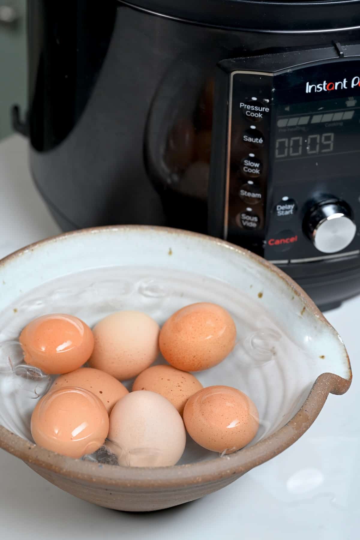 Cooked eggs in a bowl with iced water