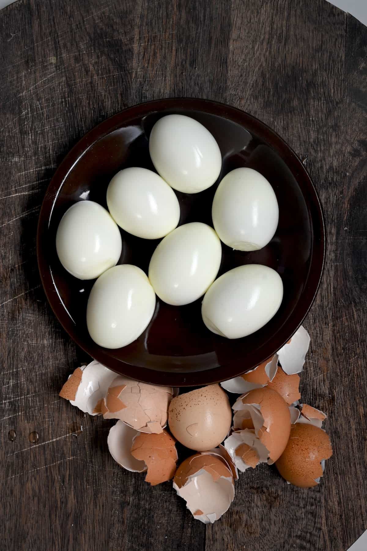 Seven cooked peeled eggs on a plate