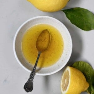 A bowl and spoon with lemon butter sauce
