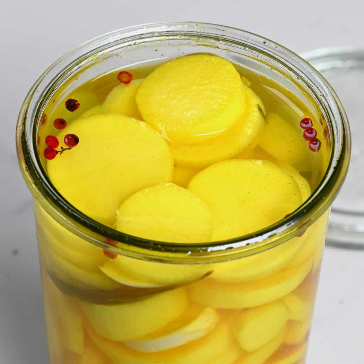 Homemade pickled daikon in a glass jar