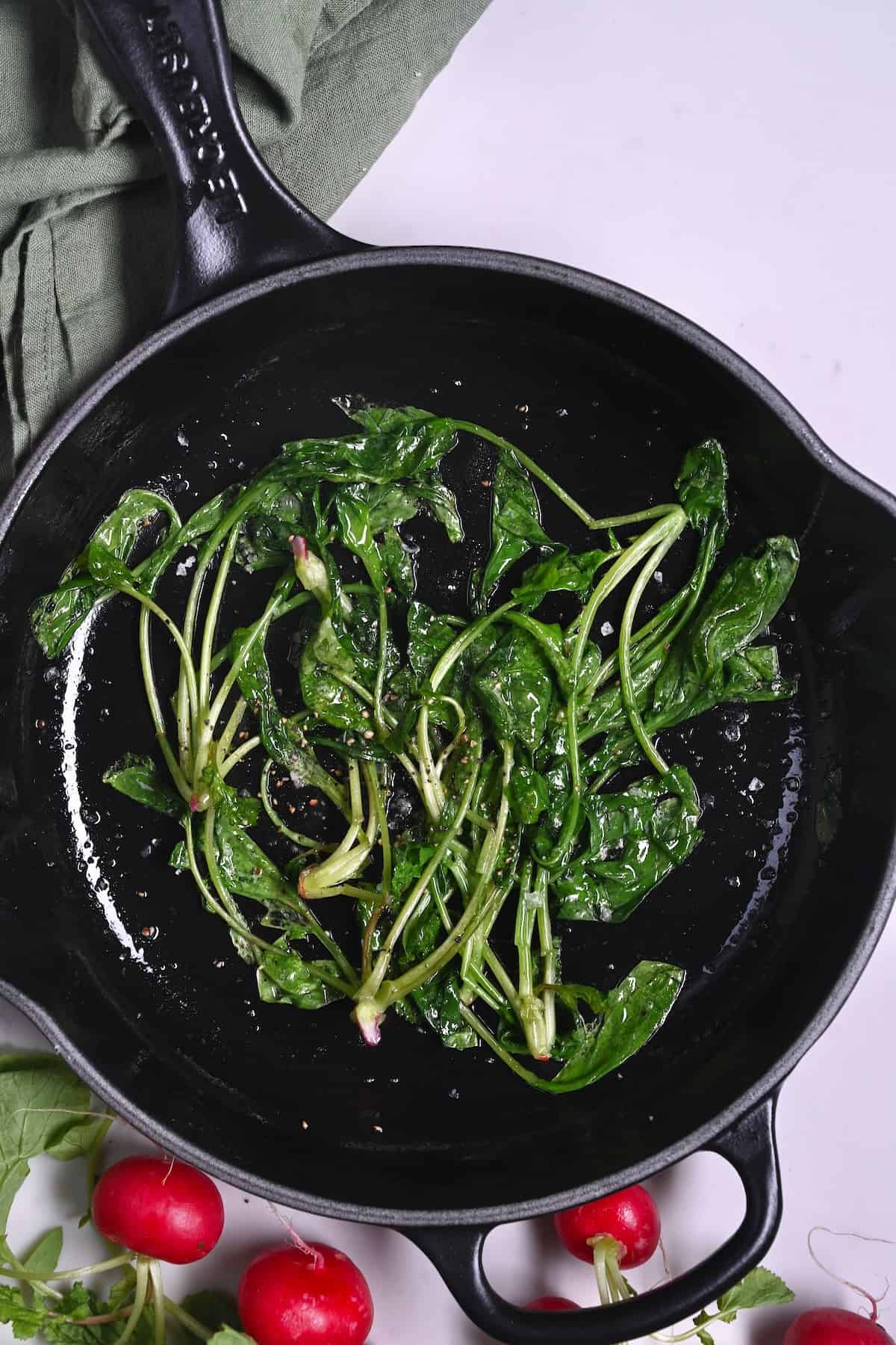 Sauteed radish greens in a pan