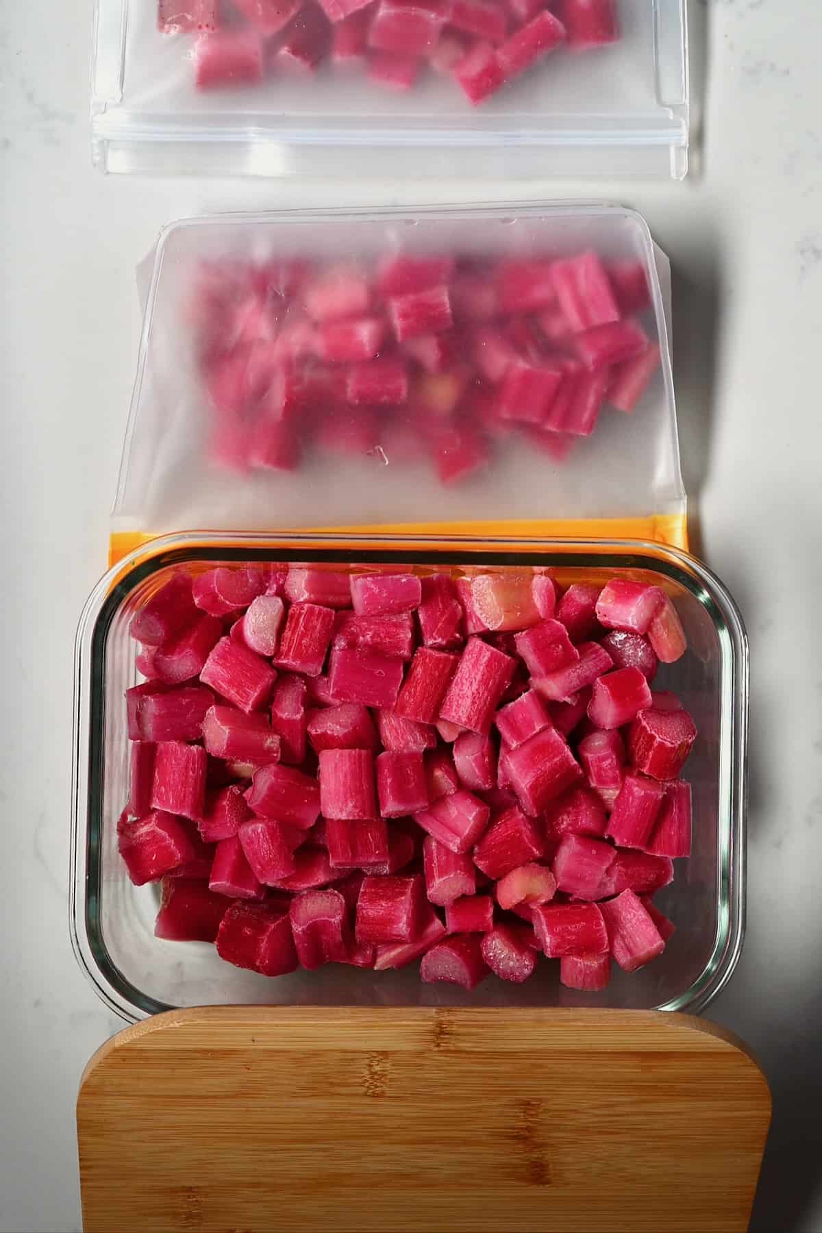 Frozen rhubarb in a container and in freezer bags
