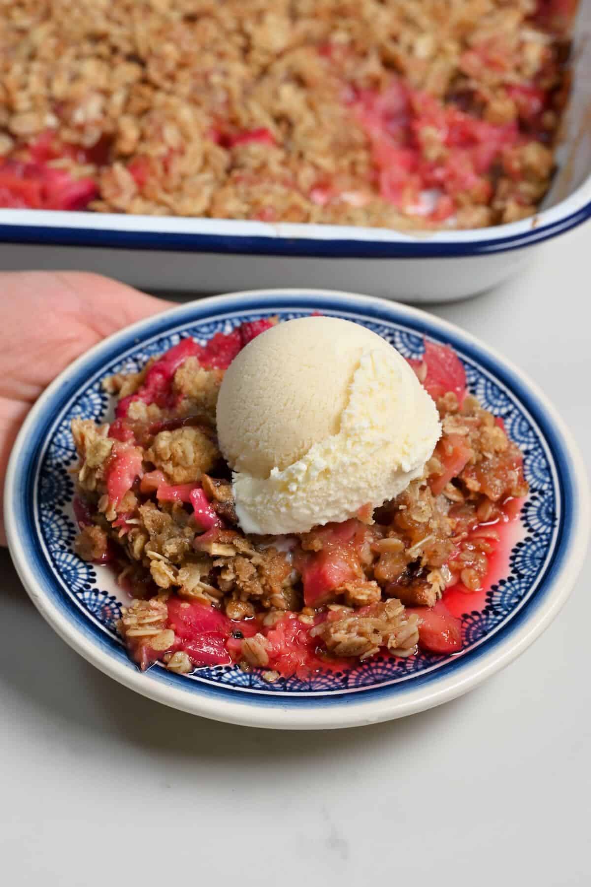 A serving of rhubarb crisp topped with ice cream