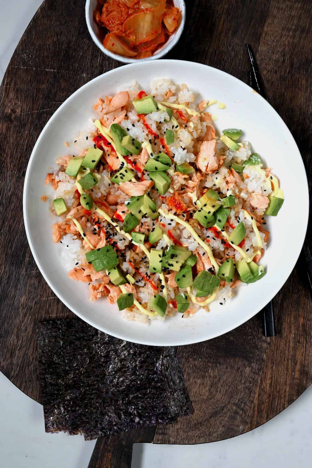 A salmon rice bowl topped with avocado and mayo