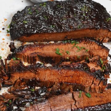 Slow cooker beef brisket cut into slices with BBQ sauce
