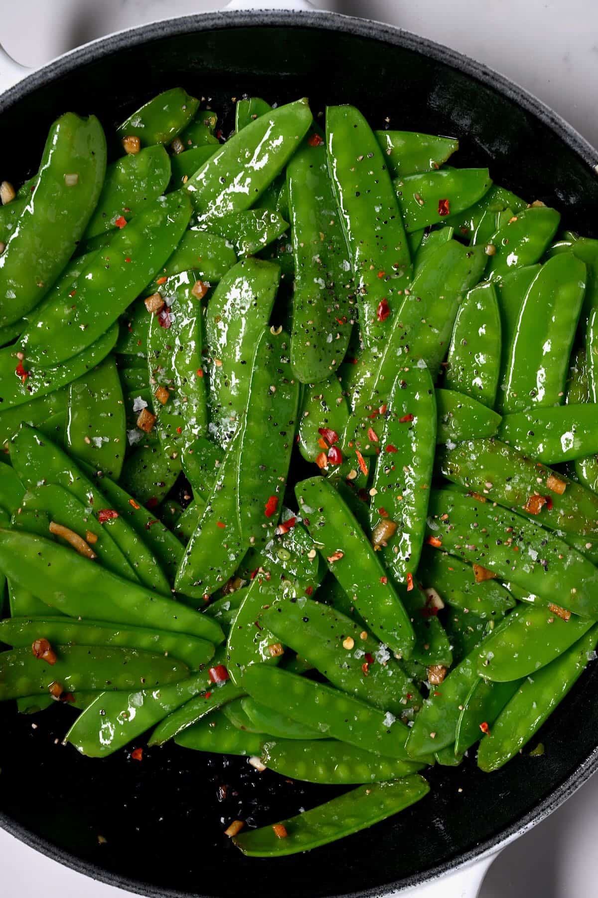 Sautéed snow peas topped with chili flakes
