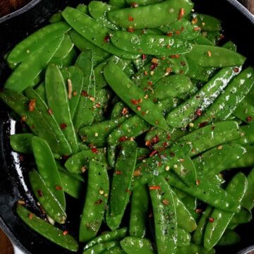 Sauteed snow peas in a skillet