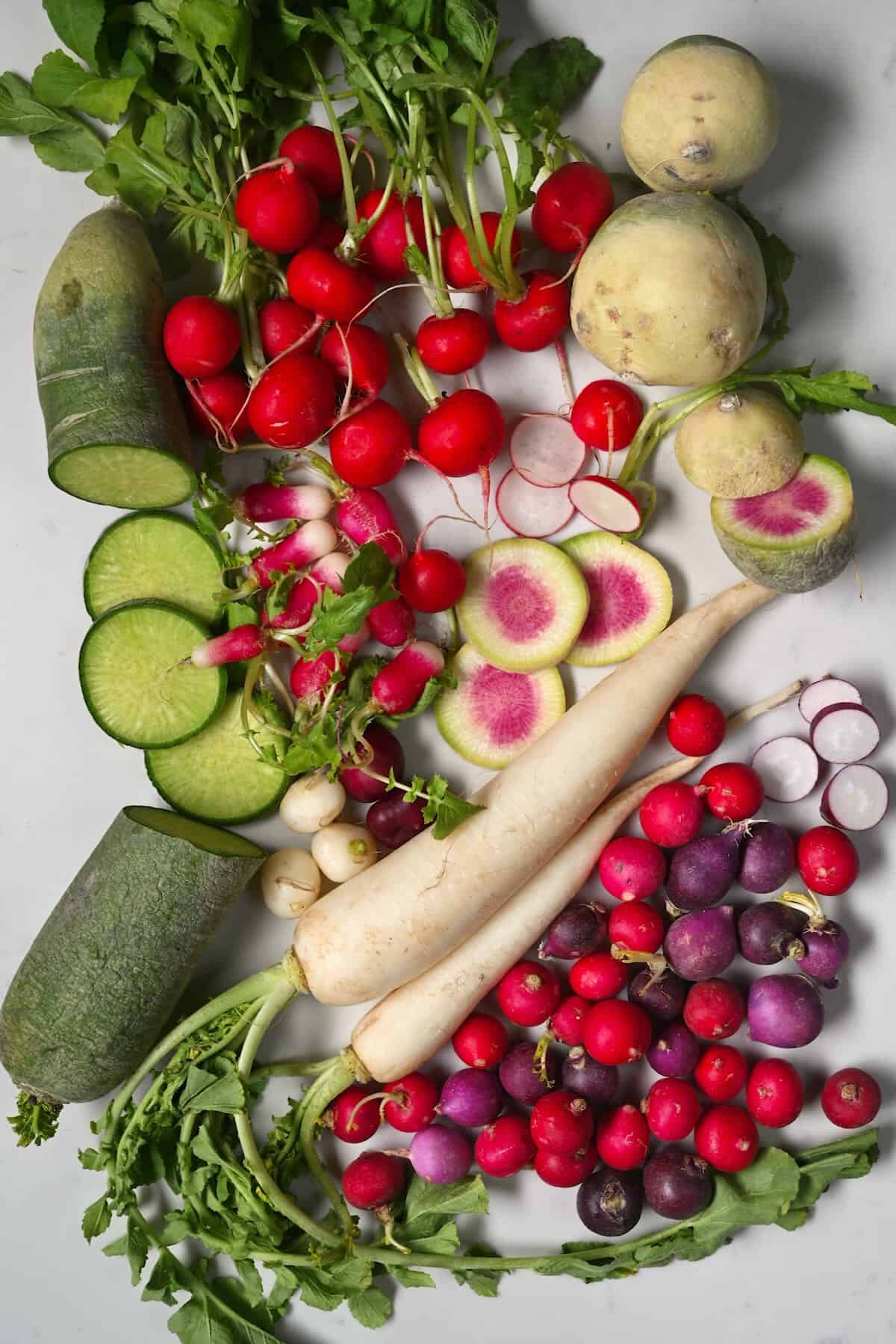 Different types of radishes on a flat surface