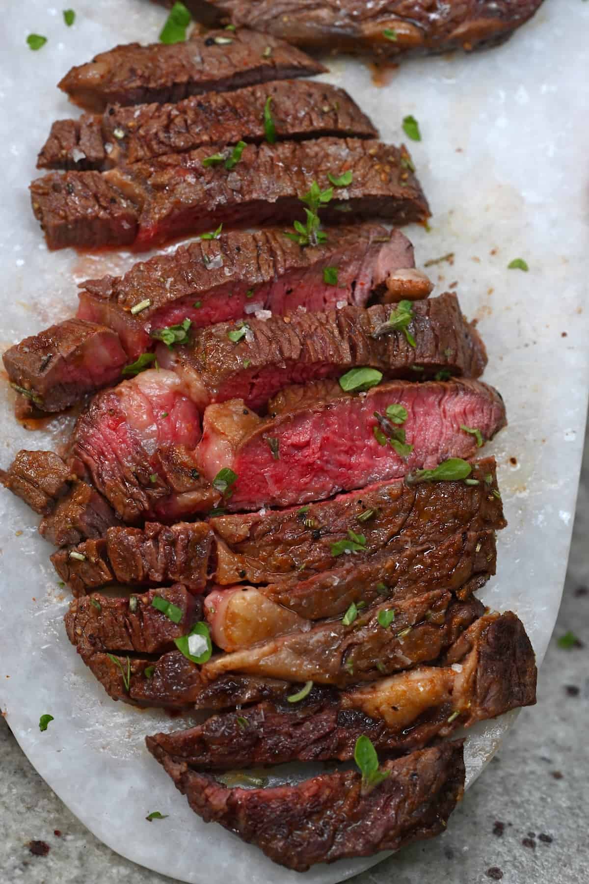 A serving of ribeye steak cut into slices