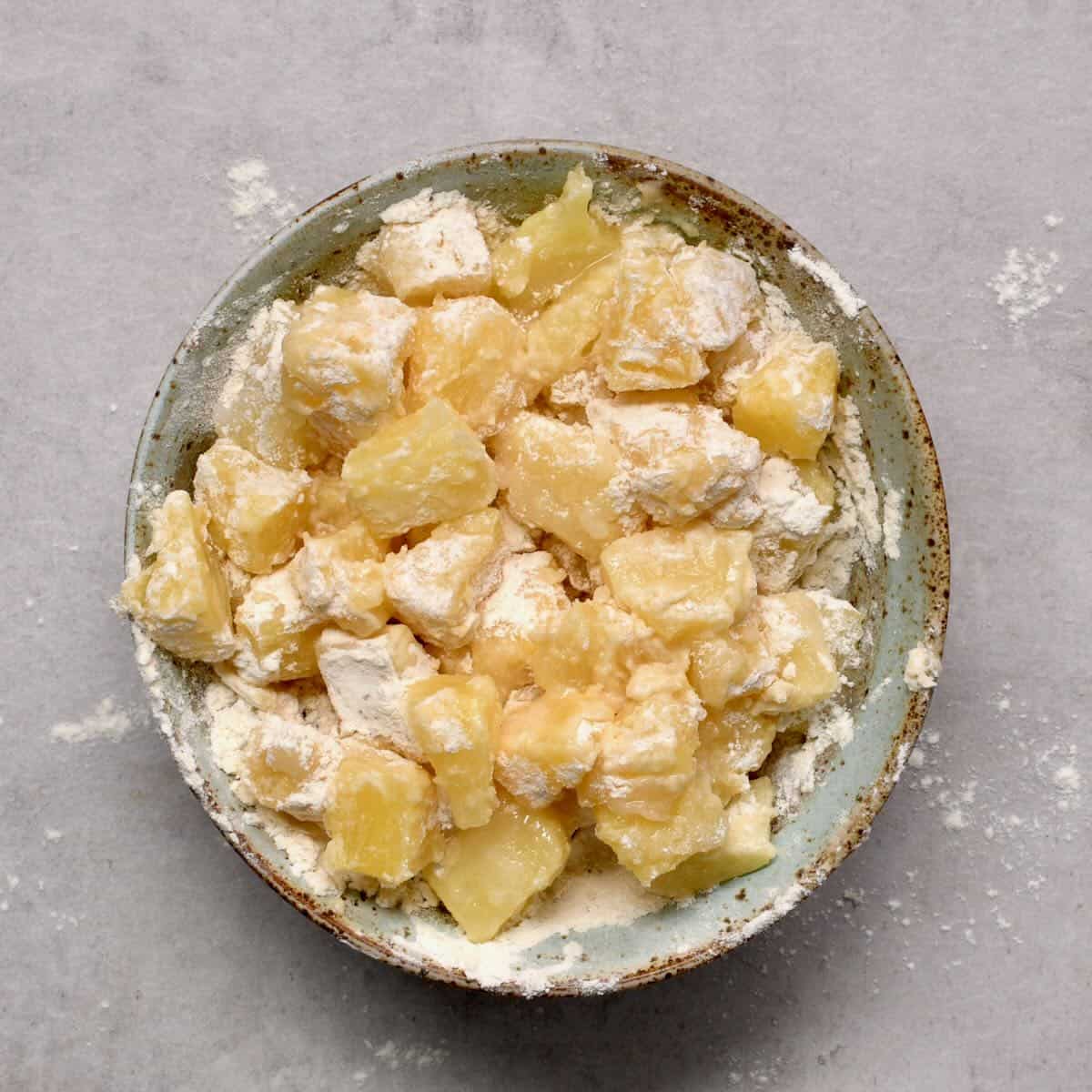 Pineapple chunks mixed with sugar and flour