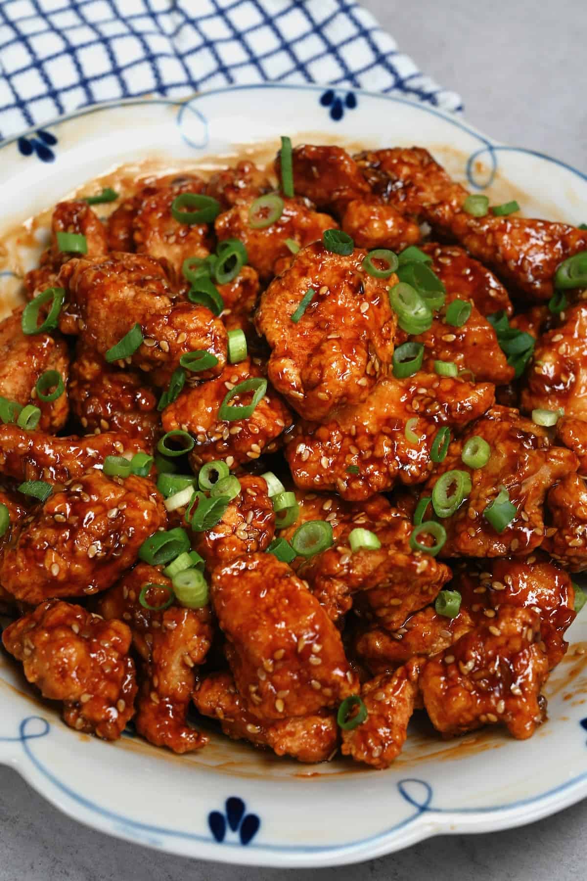 Sesame chicken topped with chopped scallions