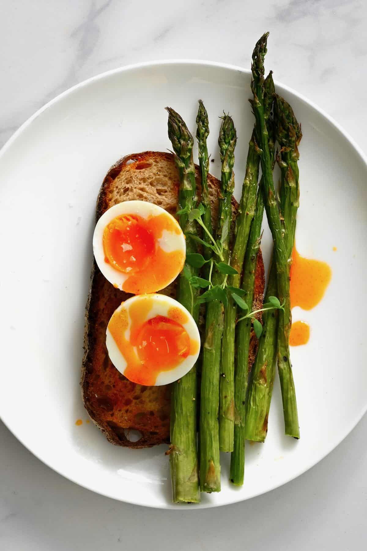 Air fryer asparagus served over toast with eggs