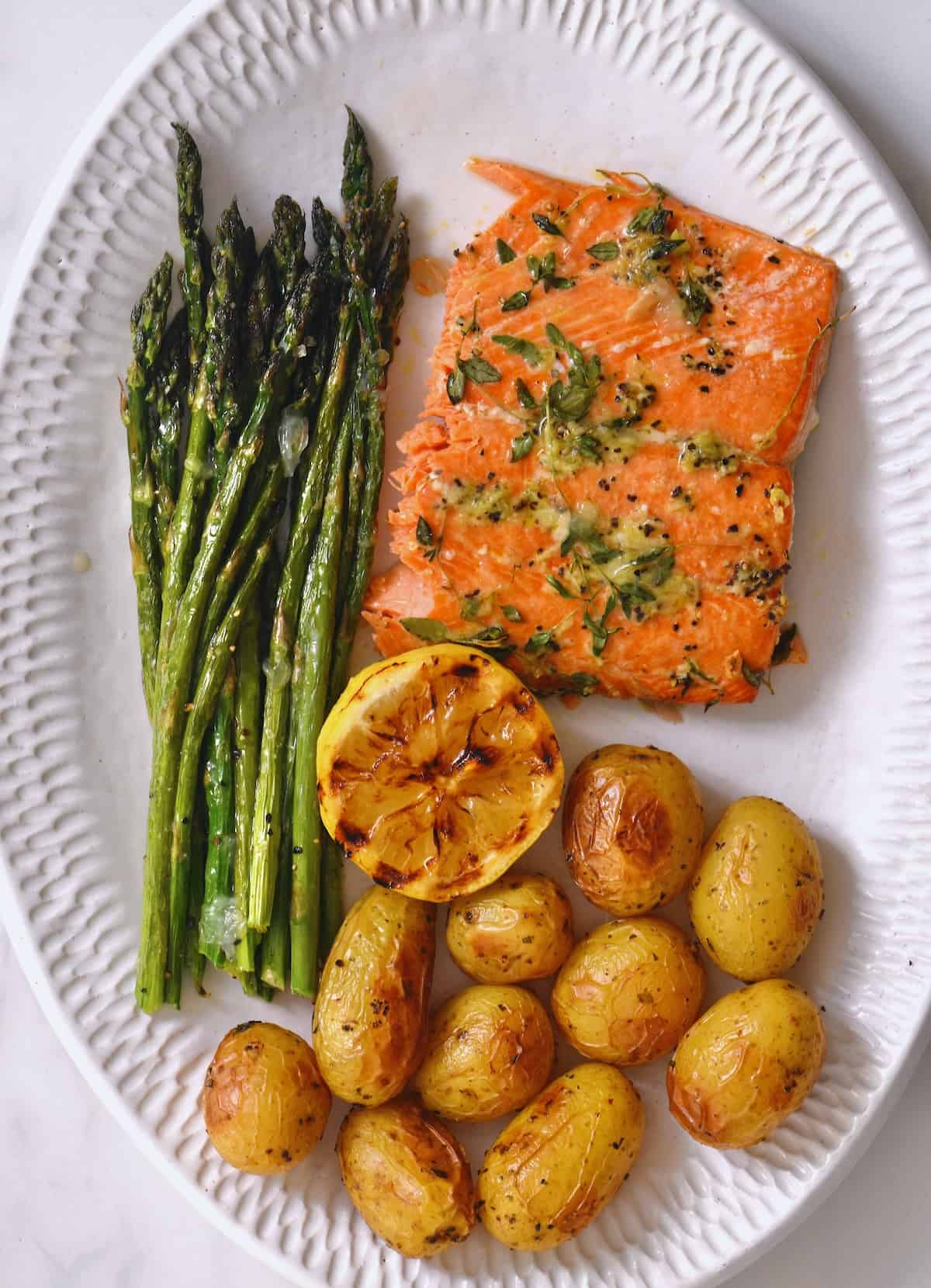 A serving of asparagus, salmon, and potatoes