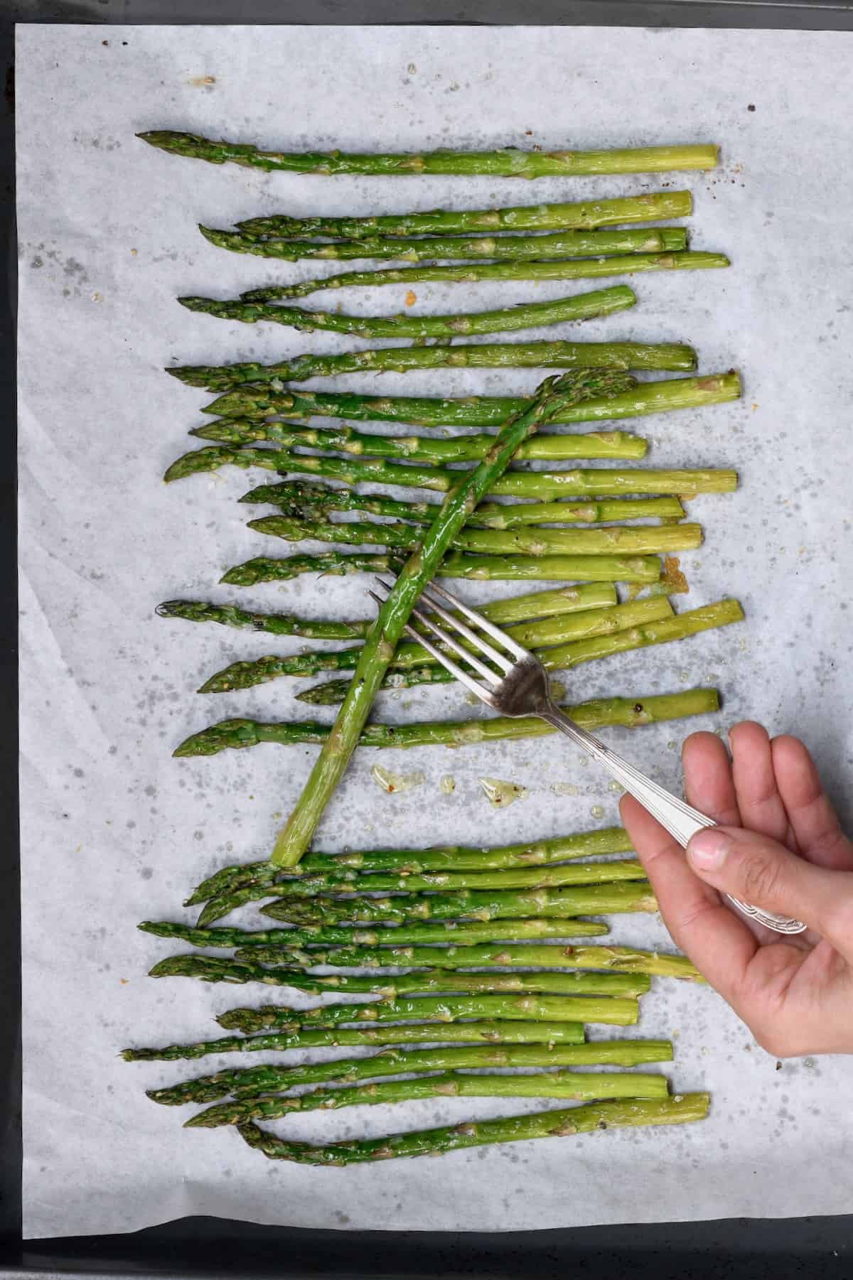 An asparagus stalk on a fork