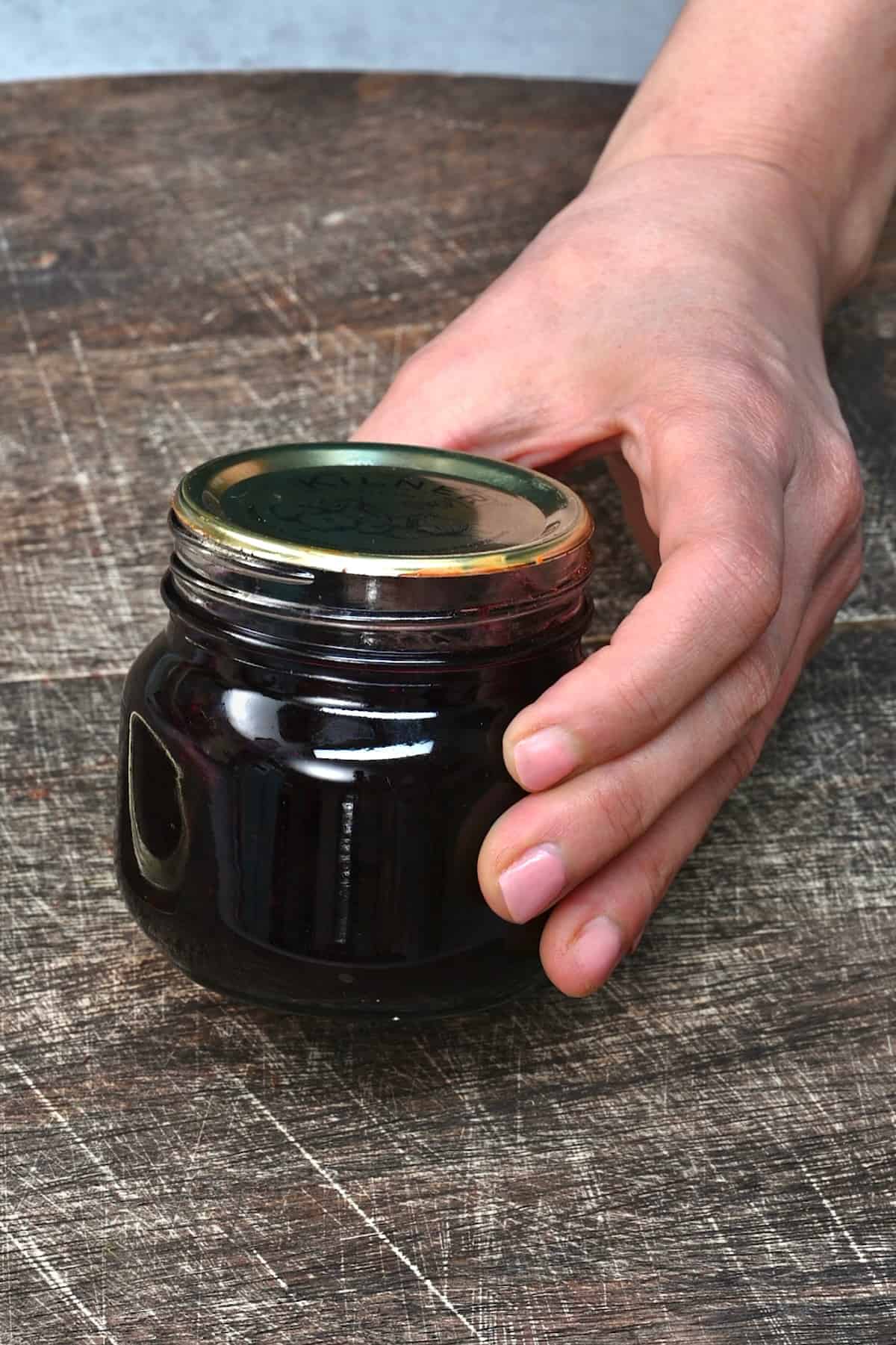 A small jar with blueberry jam