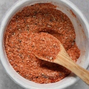 Homemade burger seasoning spice blend in a small bowl with a spoon