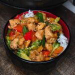 A serving of chicken stir fry over rice