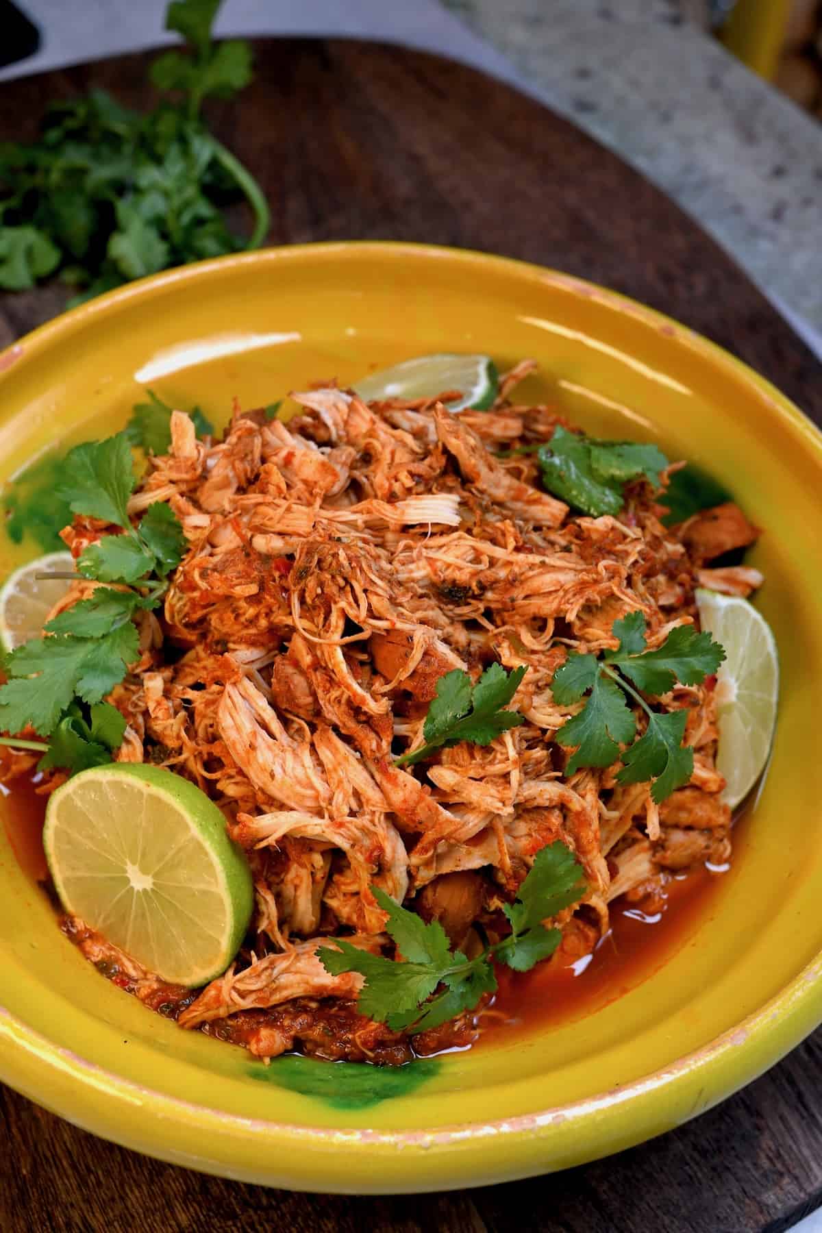 Shredded chicken served with cilantro and lime