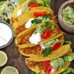 Crockpot chicken tacos topped with lettuce guacamole and tomatoes - 14