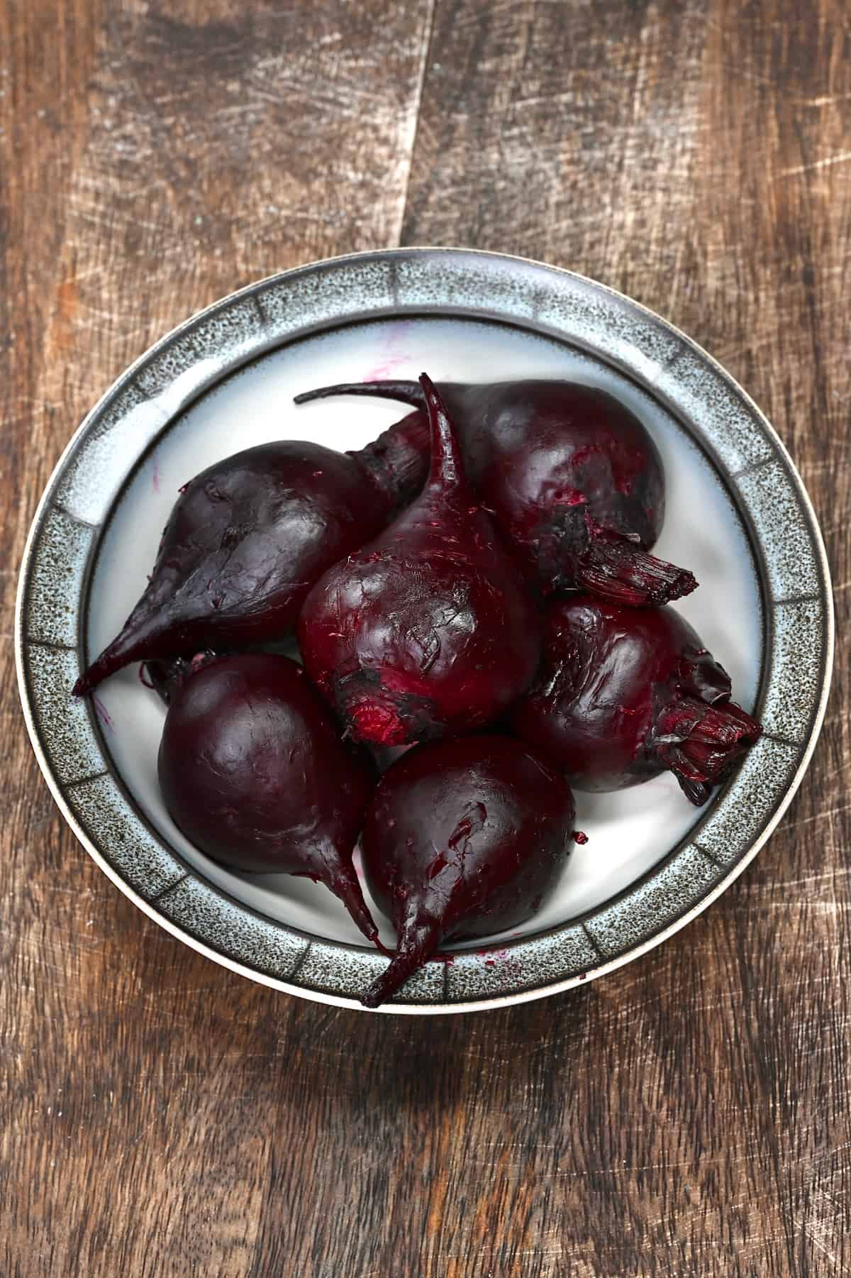 Whole roasted beets on a plate