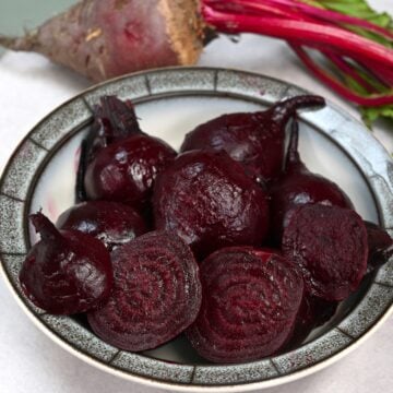 Roasted beets cut in halves on a plate
