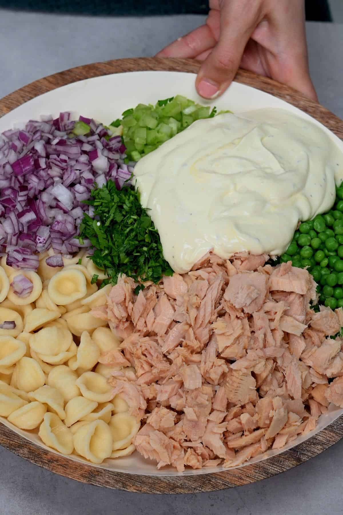 All the elements for tuna pasta salad in a bowl
