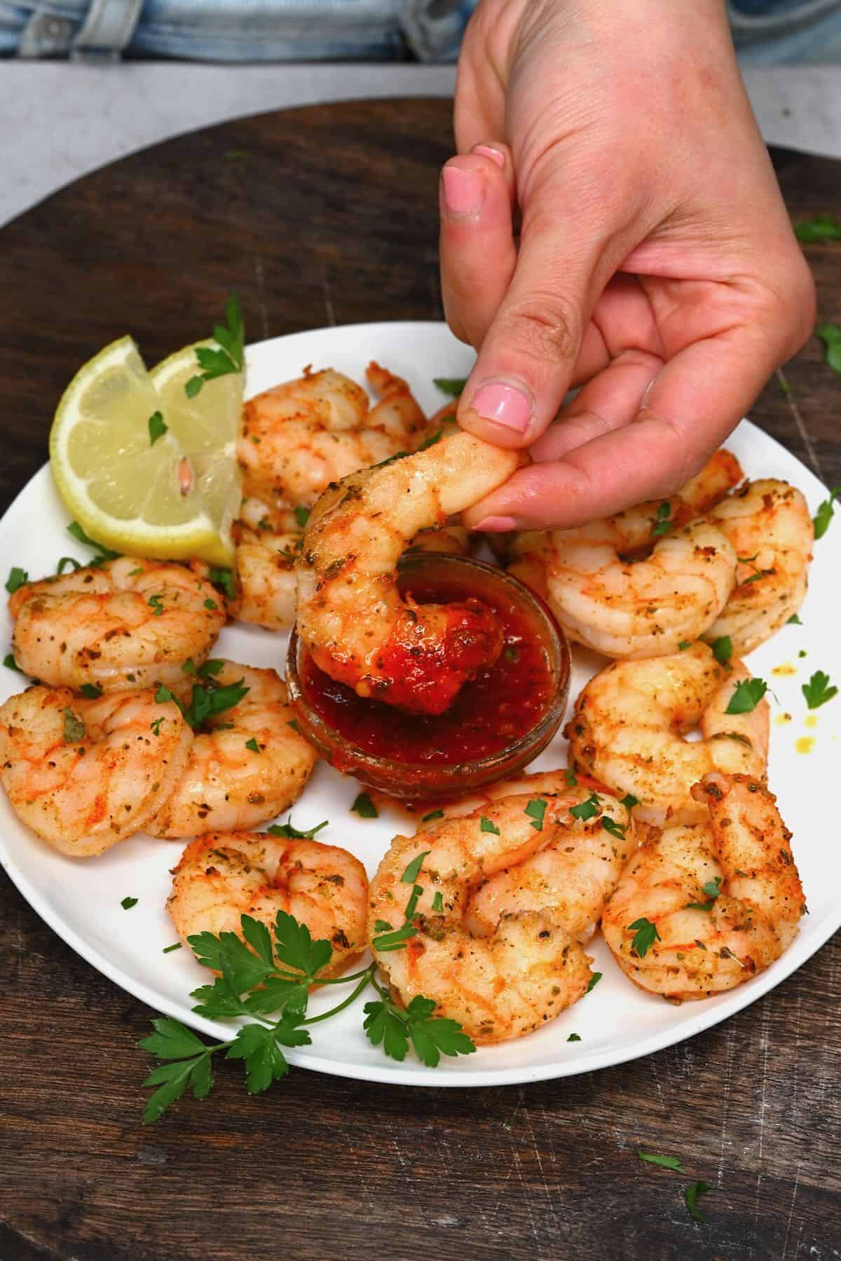 Dipping air fried shrimp in red sauce