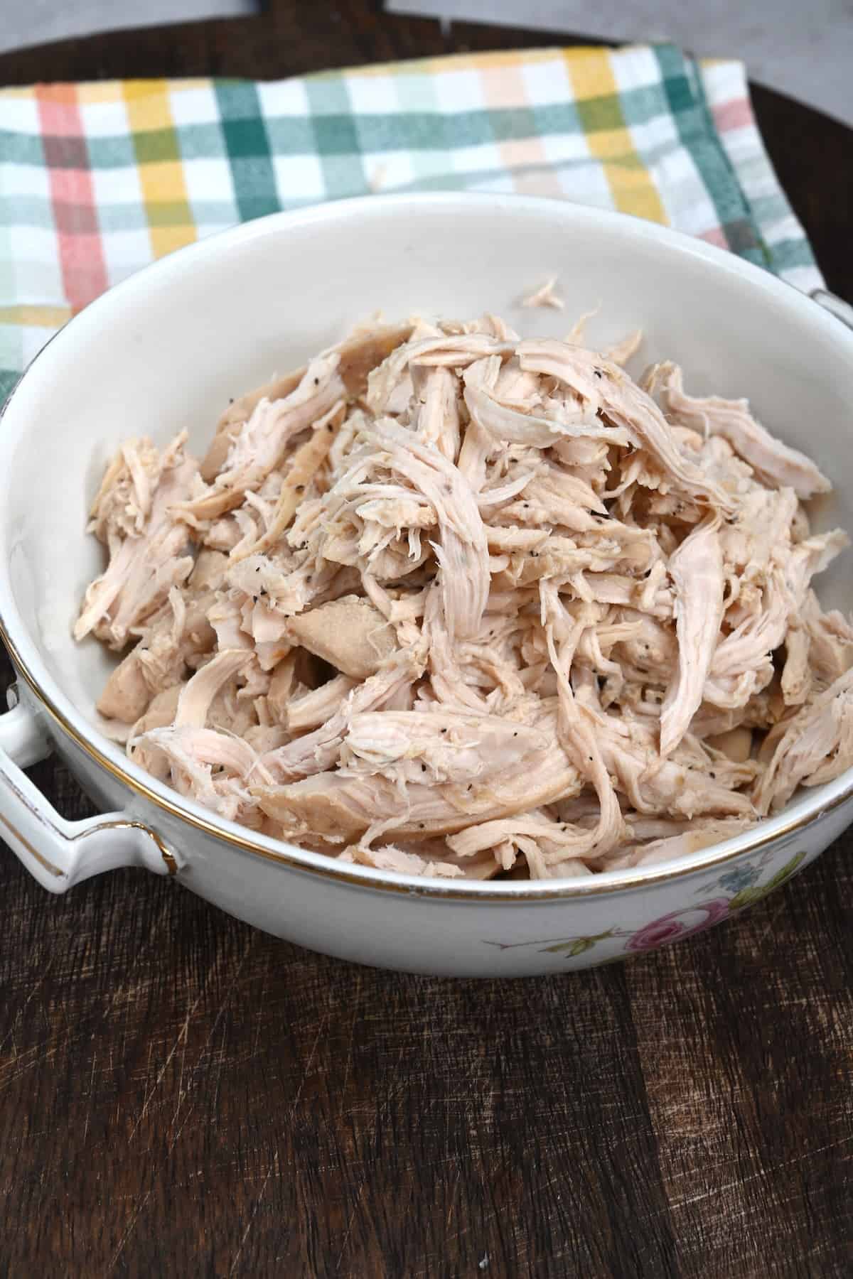 A serving bowl with shredded chicken