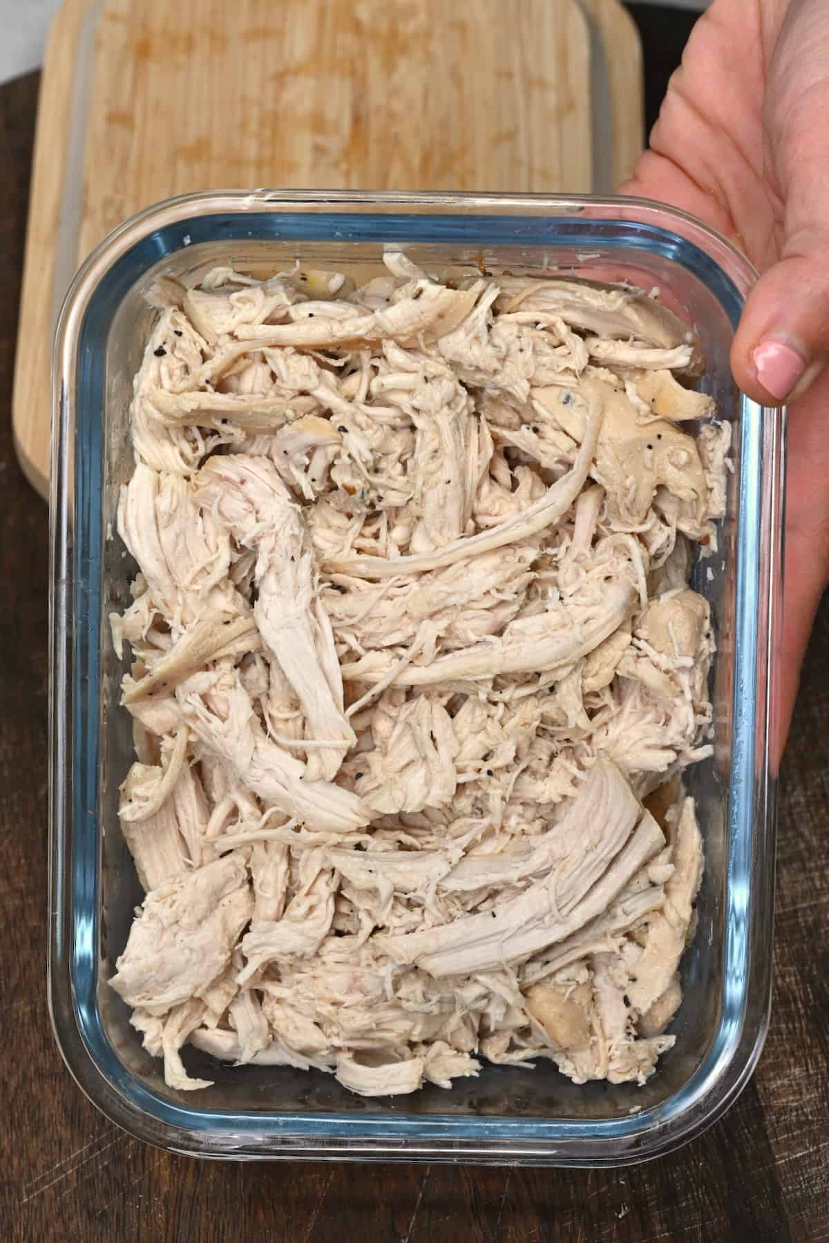 Shredded chicken in a glass container ready to store