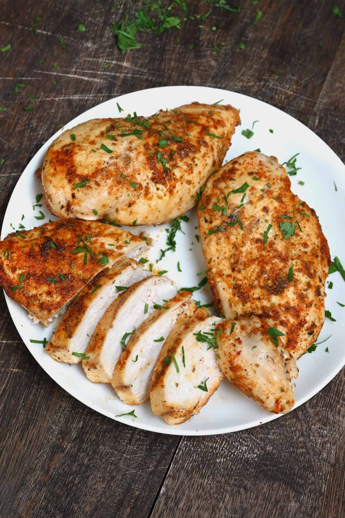 Air fried juicy chicken cut on a plate