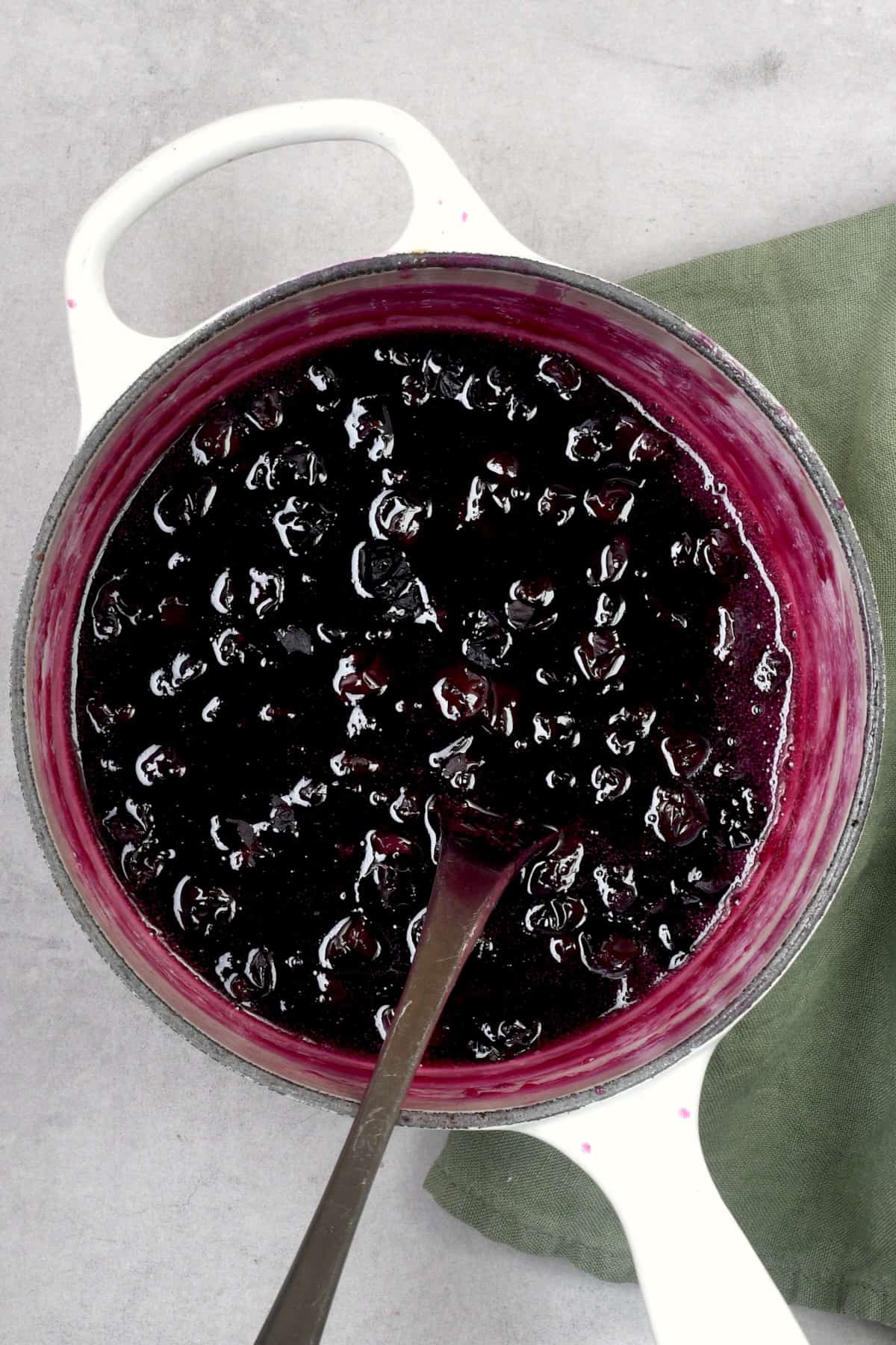 Homemade blueberry syrup in a saucepan