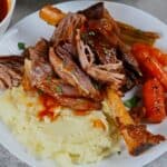 A serving of lamb shank with mashed potatoes - 14