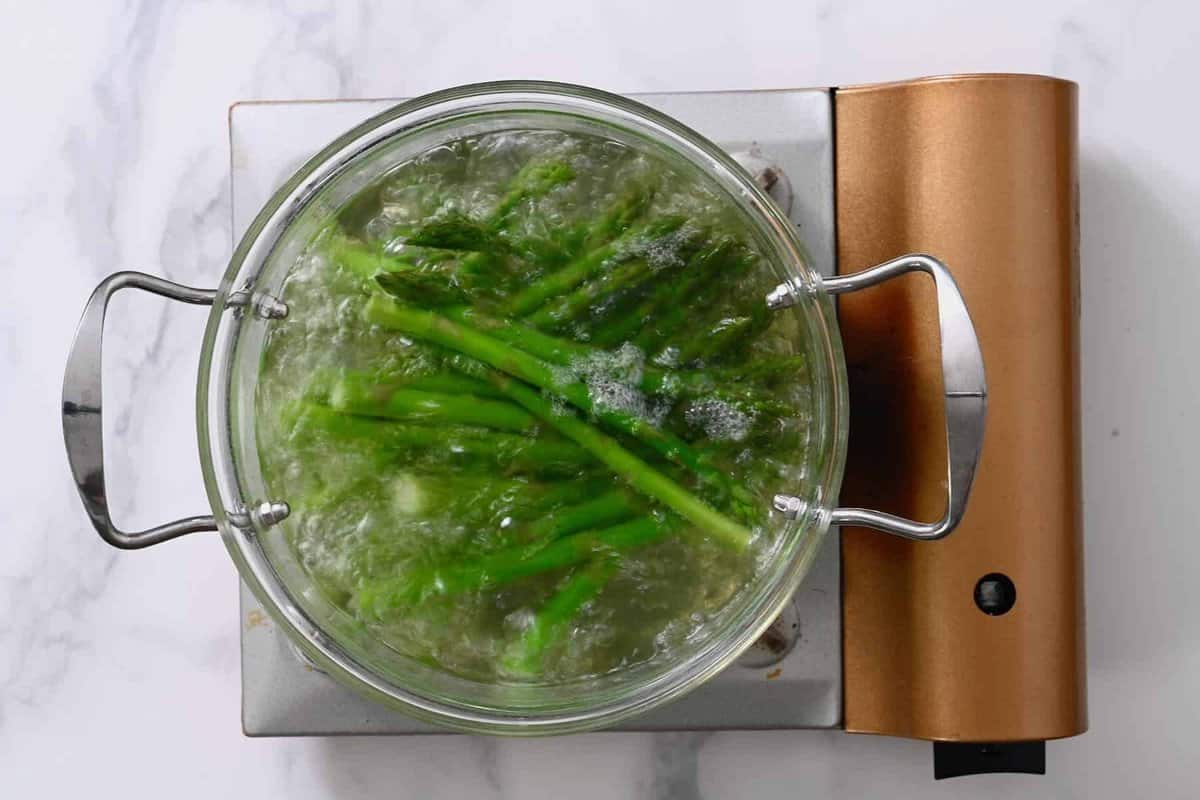 Blanching asparagus in a pot of boiling water