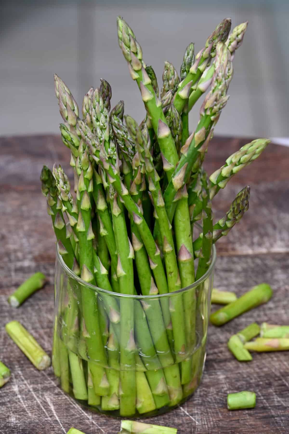 Asparagus in a small cup with water