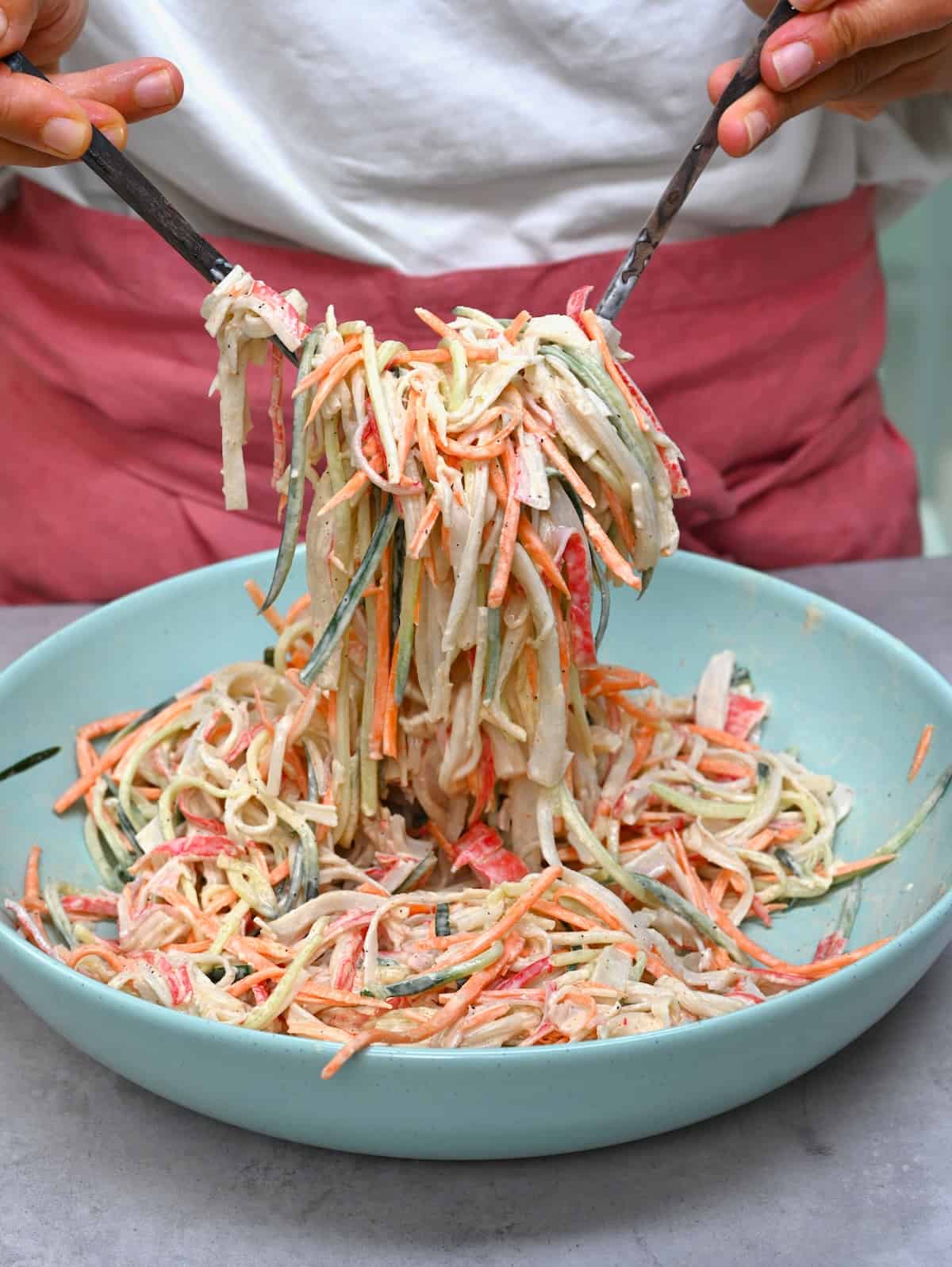 Mixing kani salad in a bowl