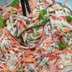 A bowl with kani salad topped with cilantro - 17