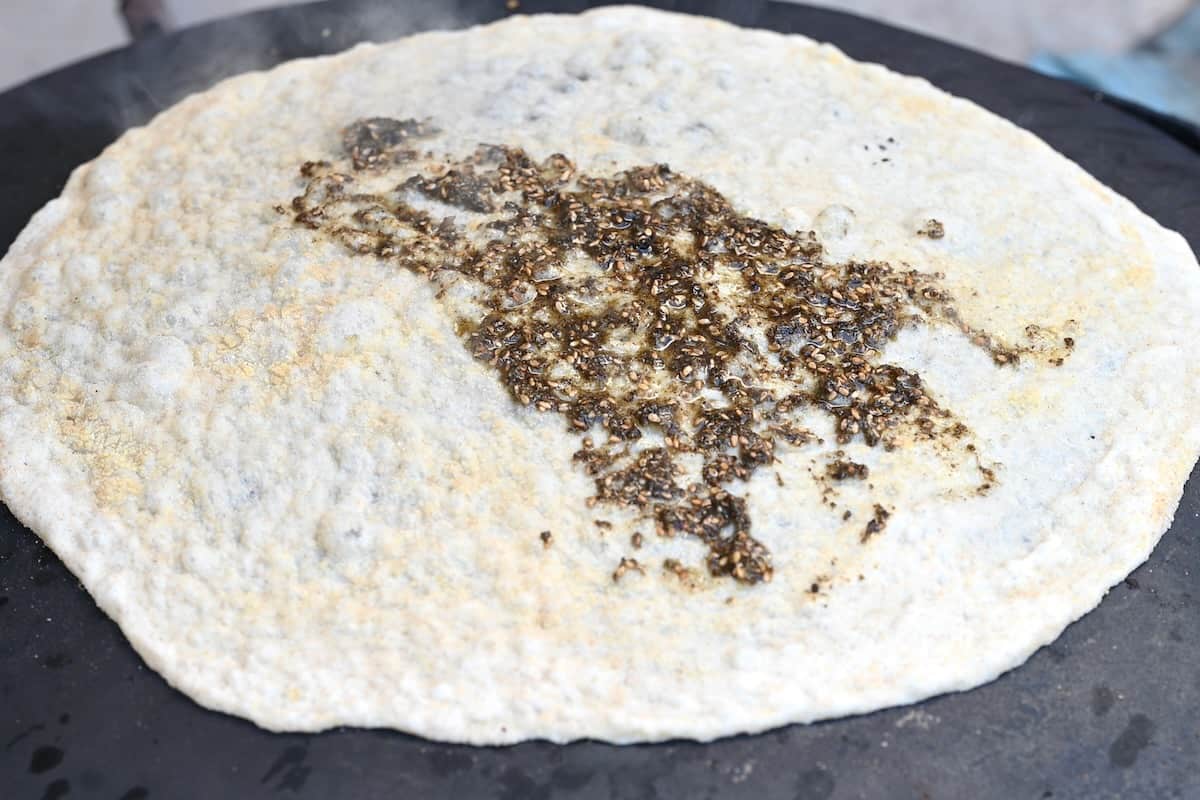 Topping markouk bread with zaatar and oil