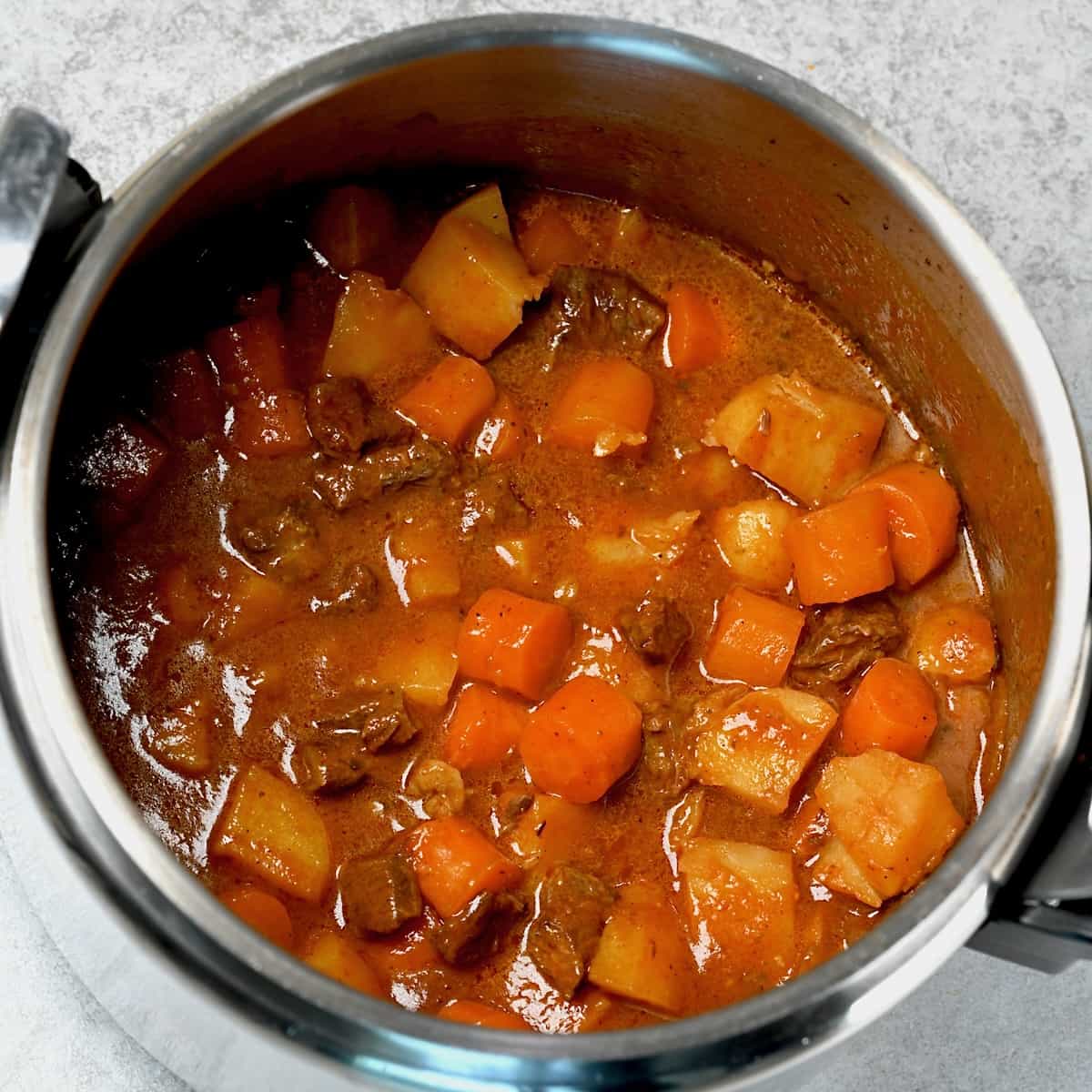 Beef stew with carrots and potatoes cooked in pressure cooker