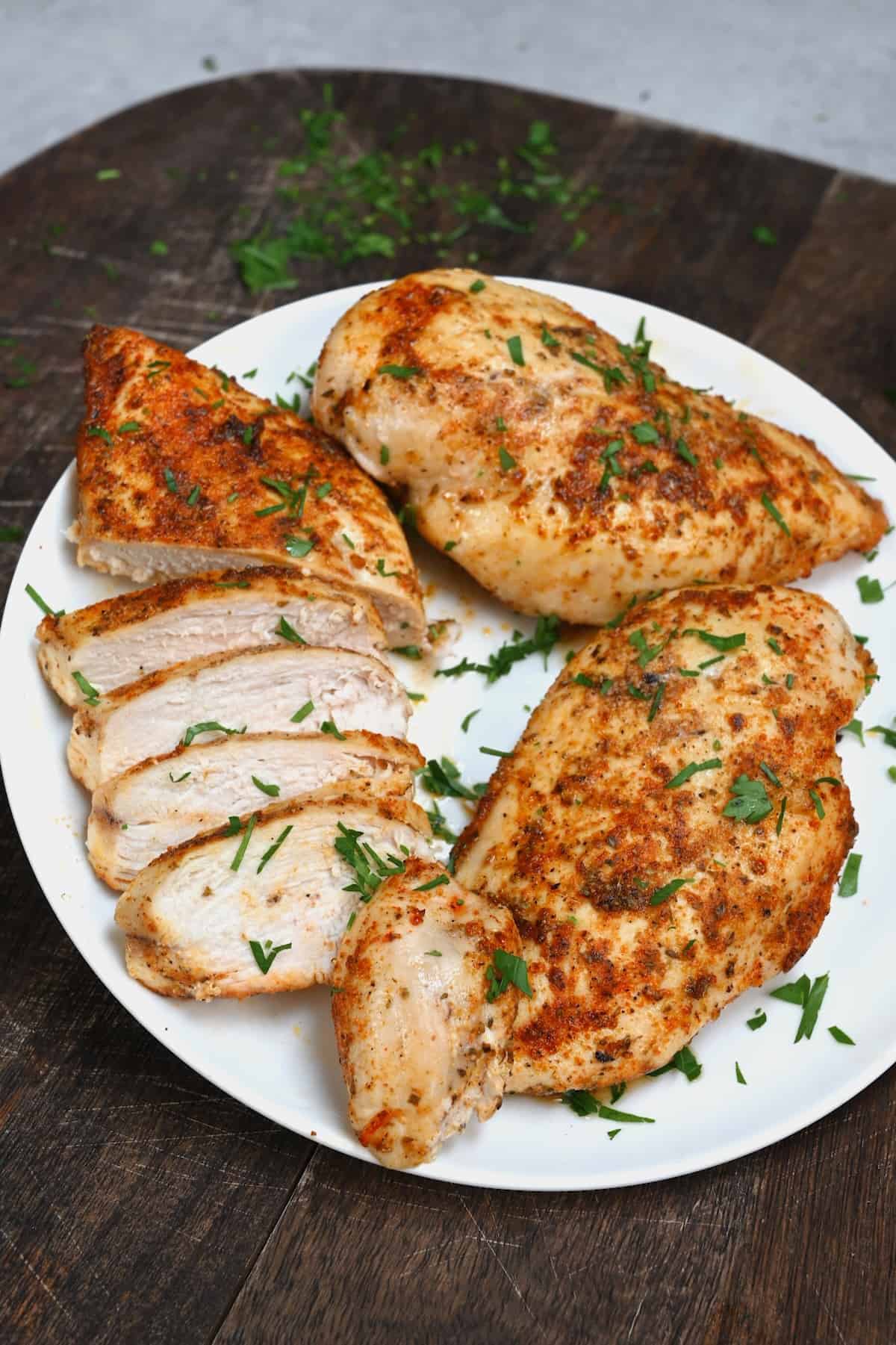 Air fried juicy chicken cut on a plate