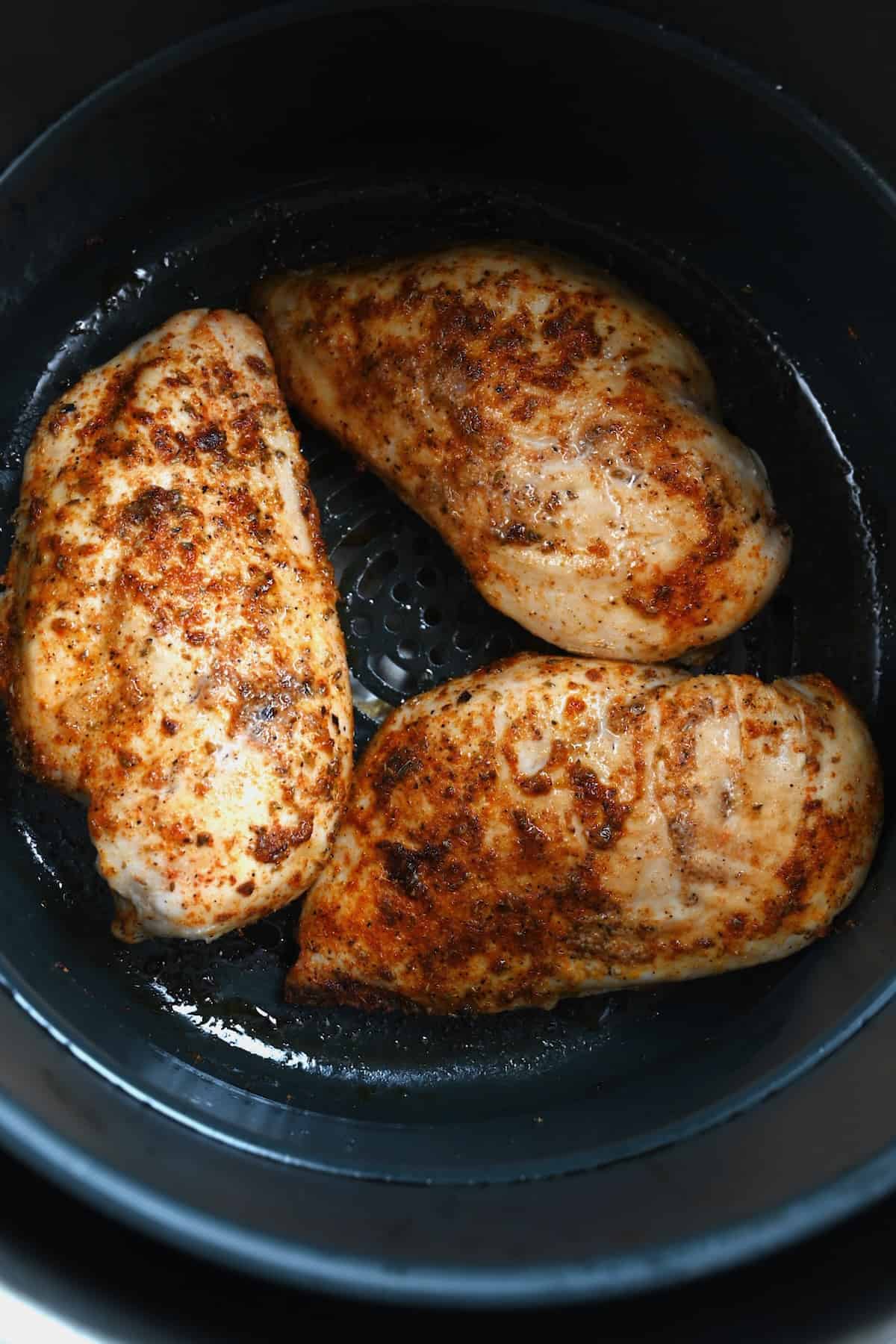 Cooked chicken breasts in an air fryer