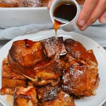 Adding sugar syrup over a serving of French toast casserole