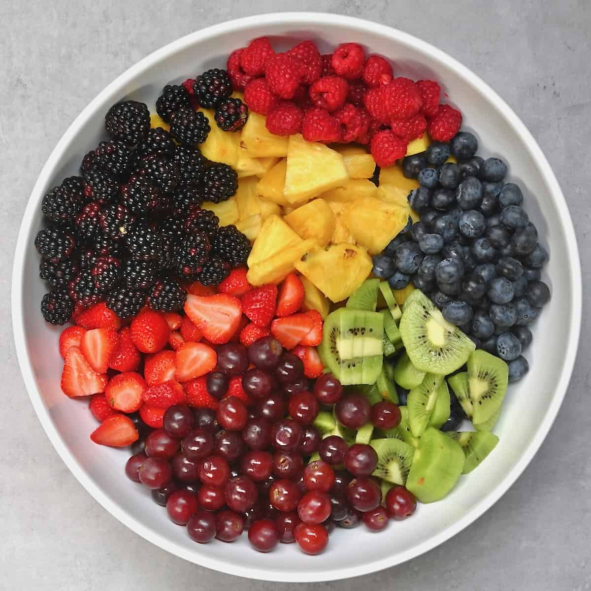 A bowl with prepped and chopped fruit