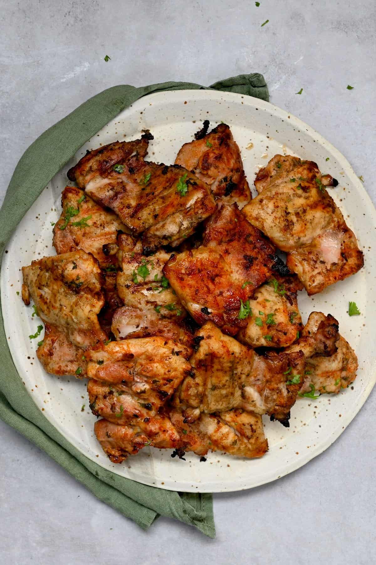 Grilled chicken thighs on a serving plate