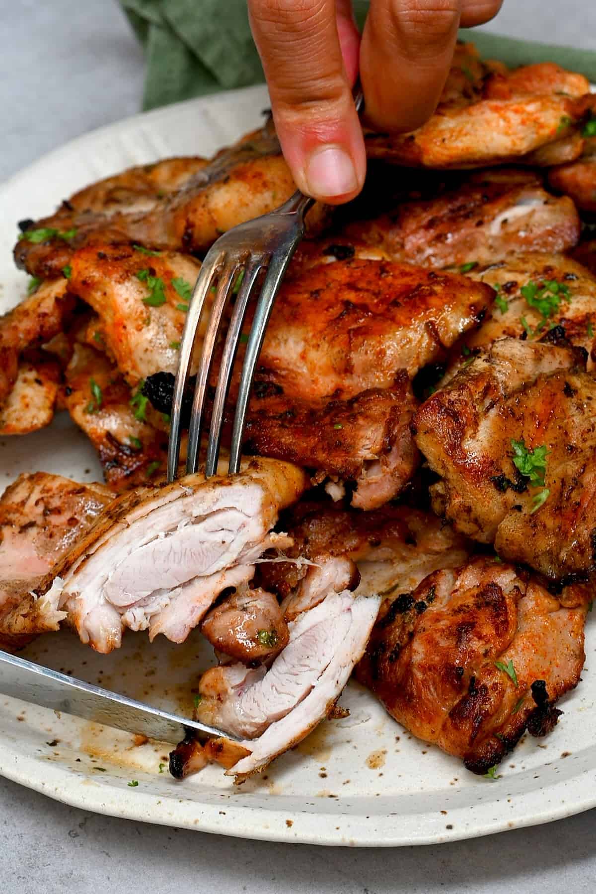 A forkful of grilled boneless skinless chicken thighs